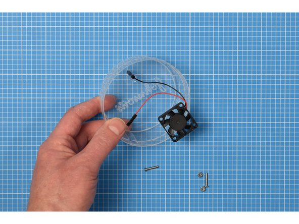 Unplug the fan from the breadboard assembly. The fan will sit inside the lid of the cotton bud packaging, which will be used upside down in the enclosure.