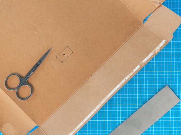 Pierce a hole in the centre of the rectangle  pointed tool such as a pen  or the small scissors.