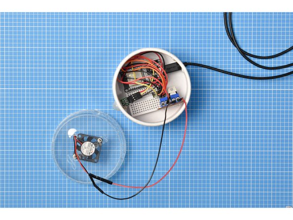 Place the breadboard assembly inside the container and attach the USB lead.
