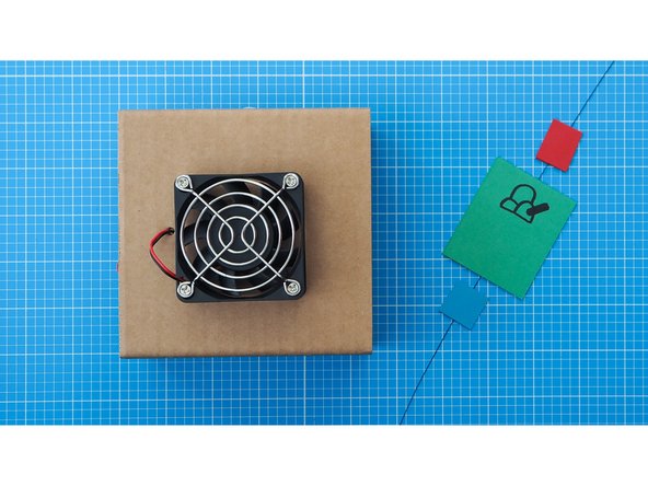 Securely tie the thread of the Thaumatrope to the middle of the fan grill.