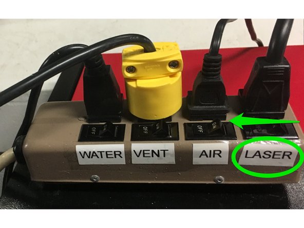 Turn off the laser power switch on the power strip.
