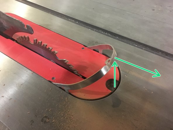 Pull up on the front of the throat plate to raise it from the recess on the table.