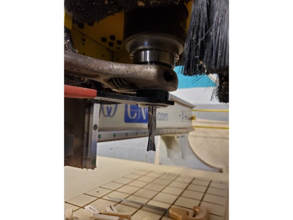 Use a wrench on the spindle flats and the collet wrench on the collet nut to loosen the nut.