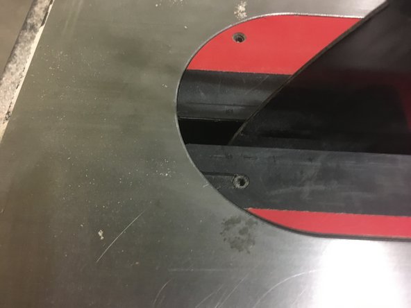 Check that the back side of the throat plate is flush or just below the surface of the saw.