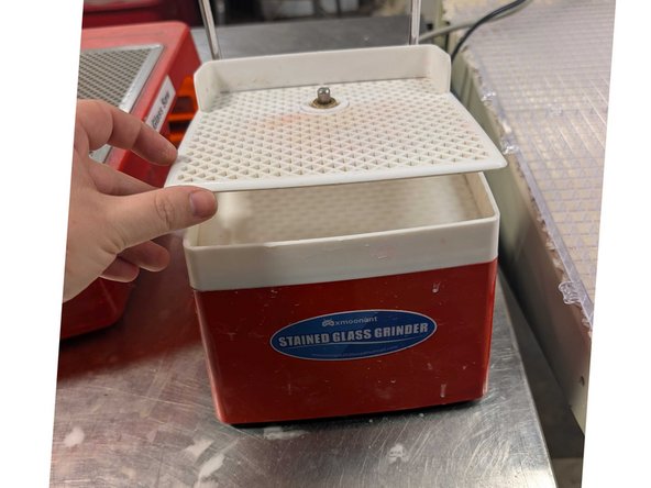 Before using, be sure that the grinder is clean and full to the mark of water beneath the white grate. Do this by lifting up the grate from the corners and adding water if needed.