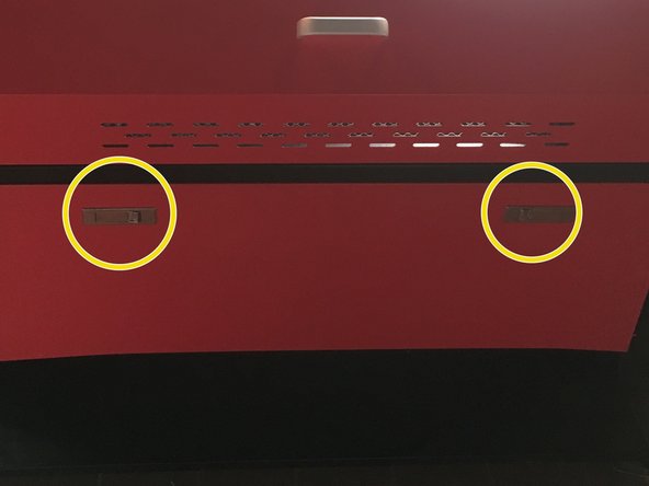 Open the door on the front of the machine by pressing the two latches.