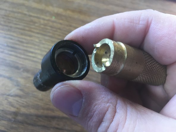 Use the lens wrench tool to loosen the ring holding the lens in place.