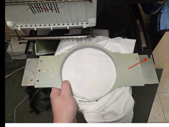 First locate the cut out on the right side of the hoop, ad align the cutout with the right hoop arm, then slide the hoop away from you into the hoop arms like the first image.