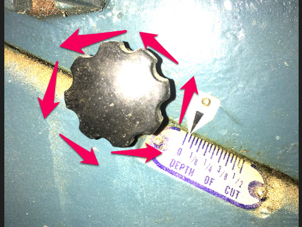 Locate the infeed table locking knob on the front of the machine, to the right of center.