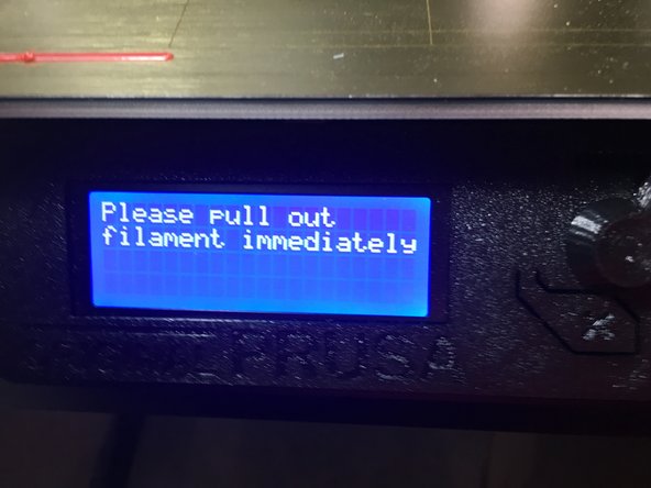 As soon as the screen prompts you, pull up on the filament to remove it from the machine.