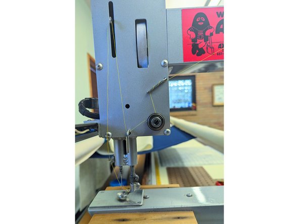 Set the tension with the dial. Tension depends on how fast you quilt and the thickness of your batting, as well as the thread you are using.