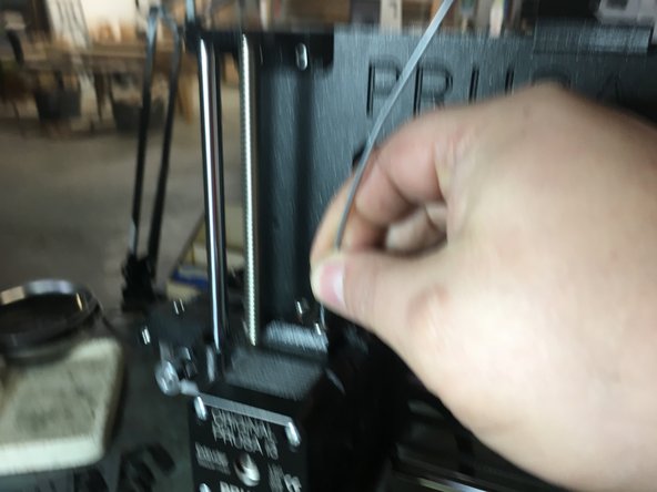 Locate the hole on the top of the extruder (the same hole you just removed filament from).