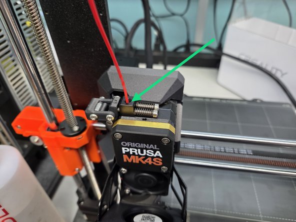 Guide the filament into the filament hole and press it in far enough that the machine beeps. Press the control knob while holding the filament in place, and the machine should handle the rest of the loading process by itself.