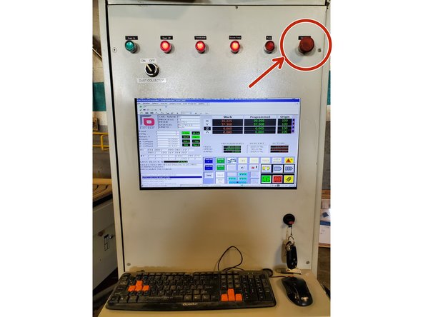 Press the E-Stop on the main control cabinet to disable the motors and spindle before proceeding