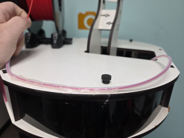 On the very top of the machine there is a Universal spool holder, Place your selected filament on it with the end of the filament going under the spool.