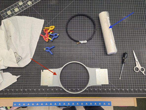First locate the proper size hoop, lay the hoop upside down, open the hoop, lay the fabric across it with the side you want embroidered facing away from you, cut the tear away backer to size, lay that over the fabric and close the hoop making sure that the fabric and backer is taught.