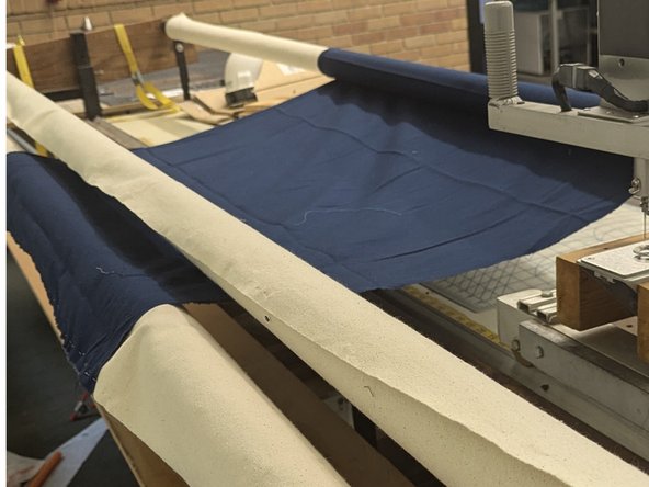 Pin entire edge of backing to edge of leader cloth, ensuring is is flat and even.