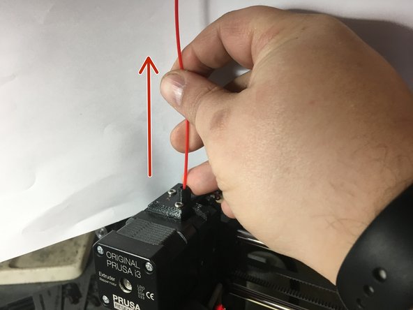 As soon as the screen prompts you, pull up on the filament to remove it from the machine.