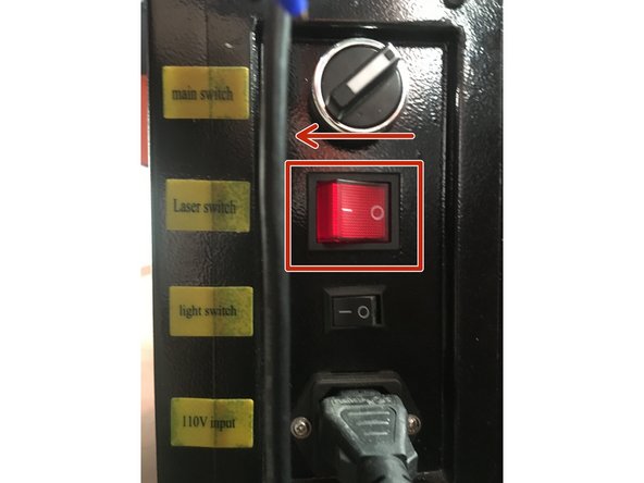 Turn on the laser power supply by flipping the switch in the I direction.