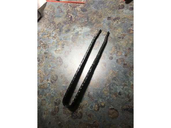 Use tweezers to remove any filament stuck to the nozzle.