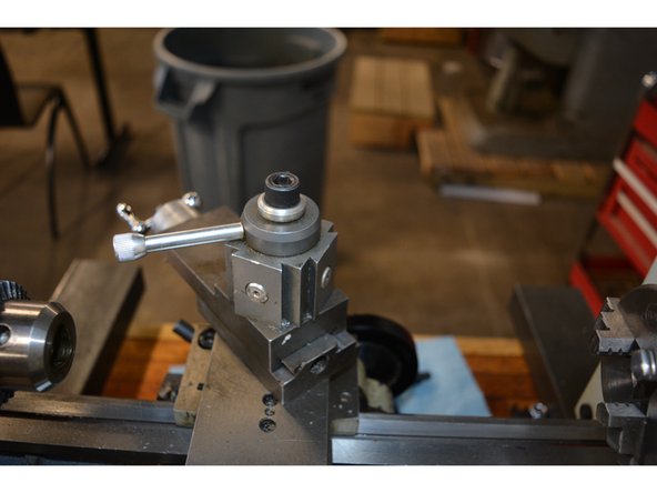 Move the carriage saddle and tailstock along the bed to allow room and clearance to the lathe chuck.