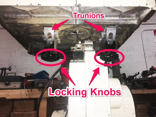 Tighten the locking knobs on the underside of the table by turning the knobs clockwise.