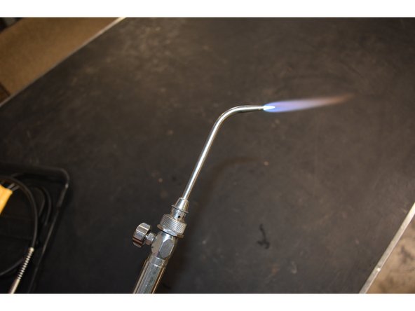 Once the flame is lit, use the torch knob to adjust the flame.