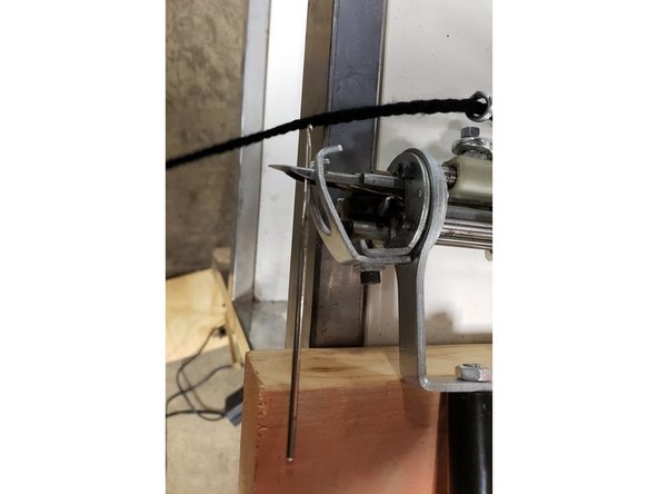 Thread the yarn, back to front, through the coiled eye on the gun