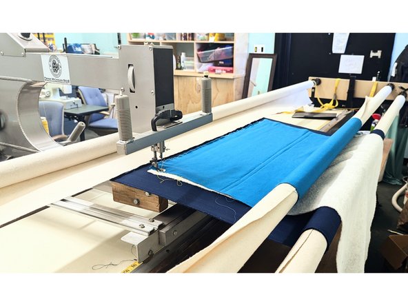 Engage roller latches and tighten the quilt back.