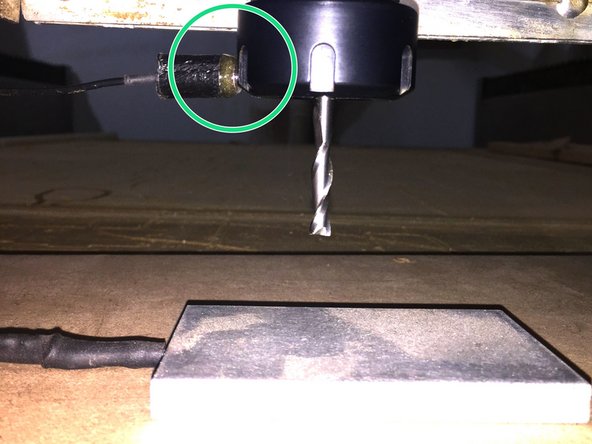 Place the touch plate under the bit.