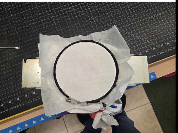 An example of properly prepared hoop is visible in the second image. Use the supplied clips to hold excess fabric.
