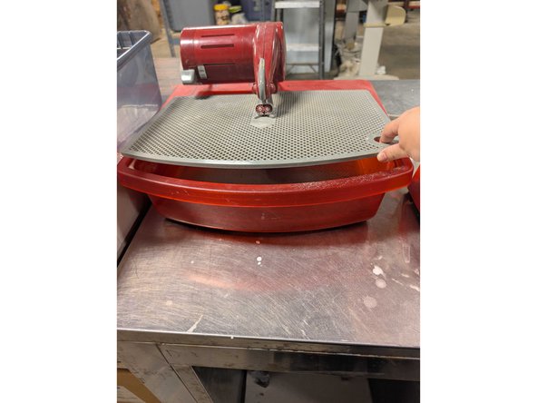 Before using, be sure that the grinder is clean and full to the mark of water beneath the grate. Do this by lifting up the grate from the corners and adding water if needed.