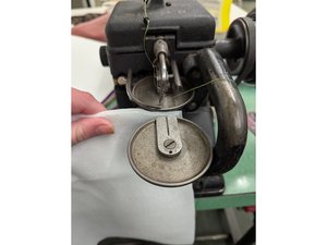 Wheel feed overseaming machine