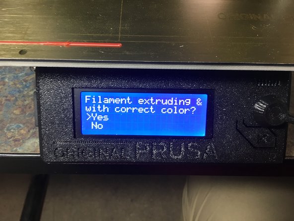 Wait for the machine to ask if the filament is extruding with the correct color.