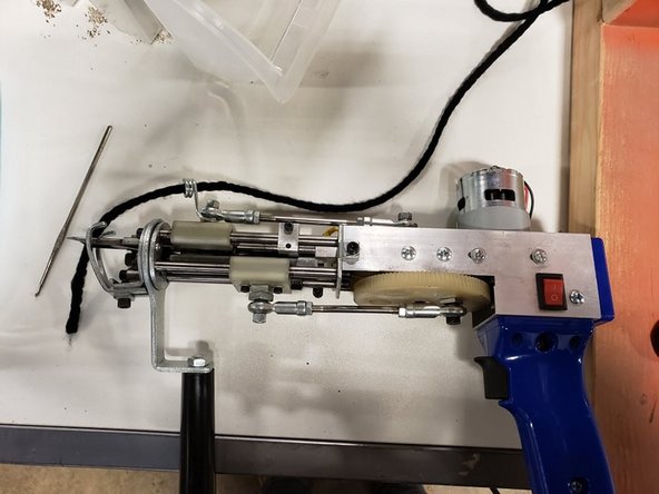 Stab skein onto the floor spindle, or yarn ball in a bowl. Thread through an eye in the frame