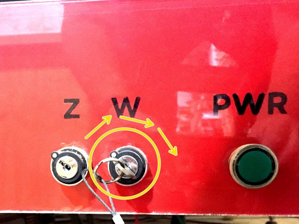 Insert the wrench key and turn to the &quot;ARM&quot; position.