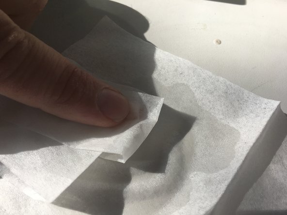 Use an alcohol moistened Kimwipe to clean both side of the lens.