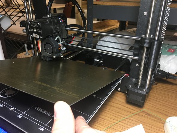 Hold the front edge of the steel sheet up while you slide it toward the back of the machine.