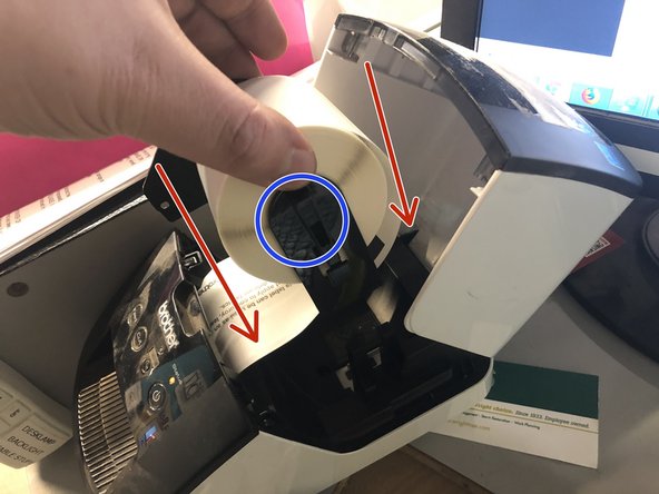 Install the new label roll in the same manner as you removed the old one.