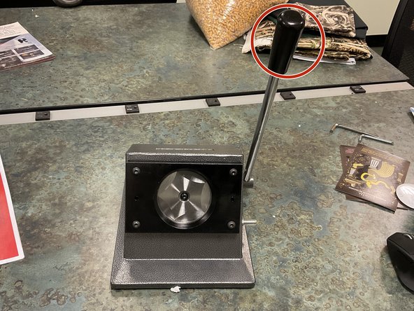 Pull down on the handle to cut the circle.  There is a rubber stop on the machine that will stop the handle from going too far.