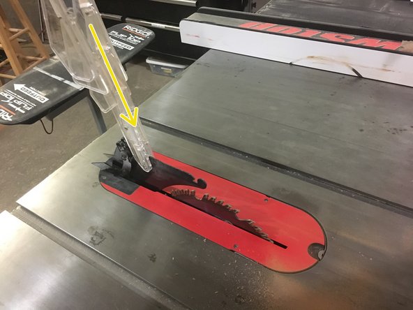 With the plastic guard facing towards the ceiling, insert the pin into the slot on the metal guard.