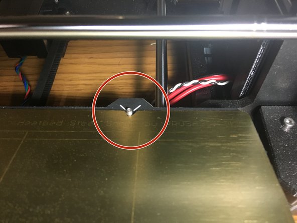 Be sure the two notches in the plate fully seat onto the pins on the back of the bed.