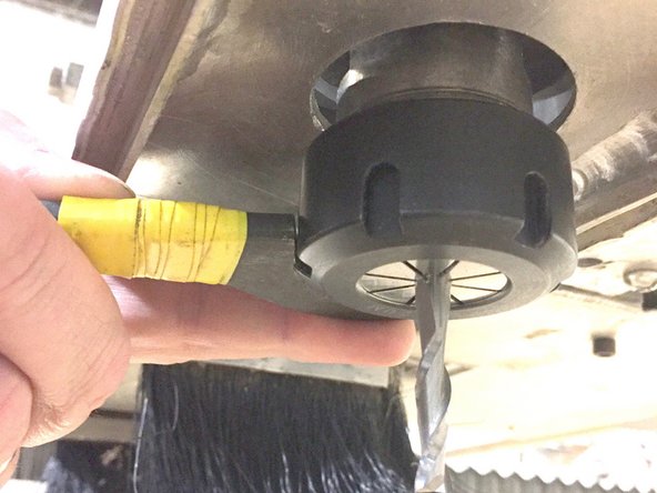 Use the bottom wrench on the collet nut.