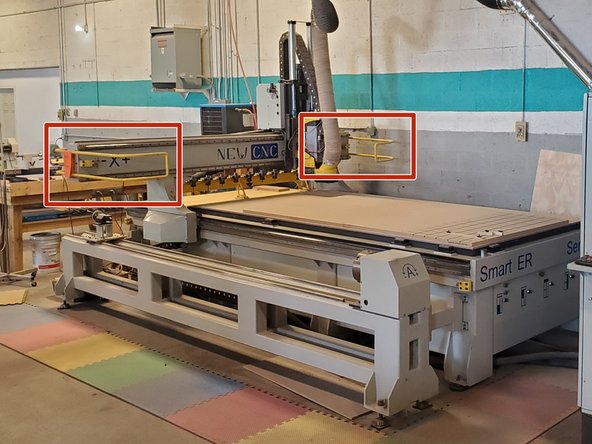 The yellow bump bars on either side of the X-axis gantry.