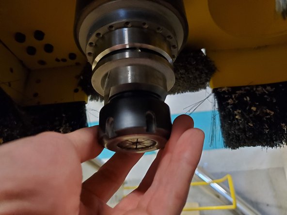 Start threading the collet and nut onto the tool holder by hand.