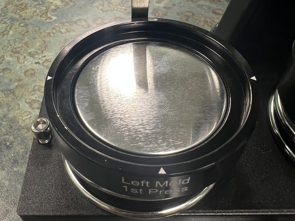 Place the metal button top into the LEFT mold with the curved smooth side facing up.