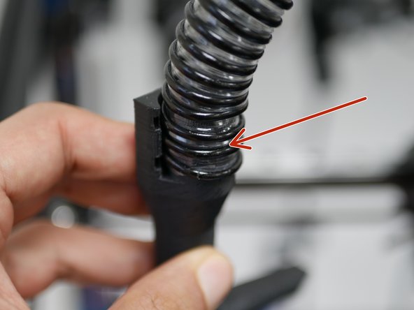 Take the open end of the cooling hose and slide it onto the fan shroud.