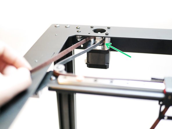 Next, wrap it around the left motor's pulley as shown.