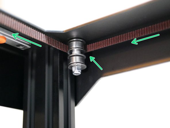 Whilst keeping some tension on the belt to prevent it from falling off the idlers, pull it forward and wrap it around the front idlers like shown.