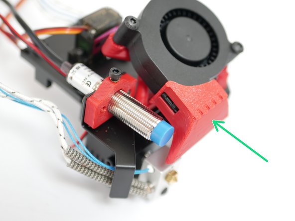 Clip the fan shroud onto the blower fan as shown.